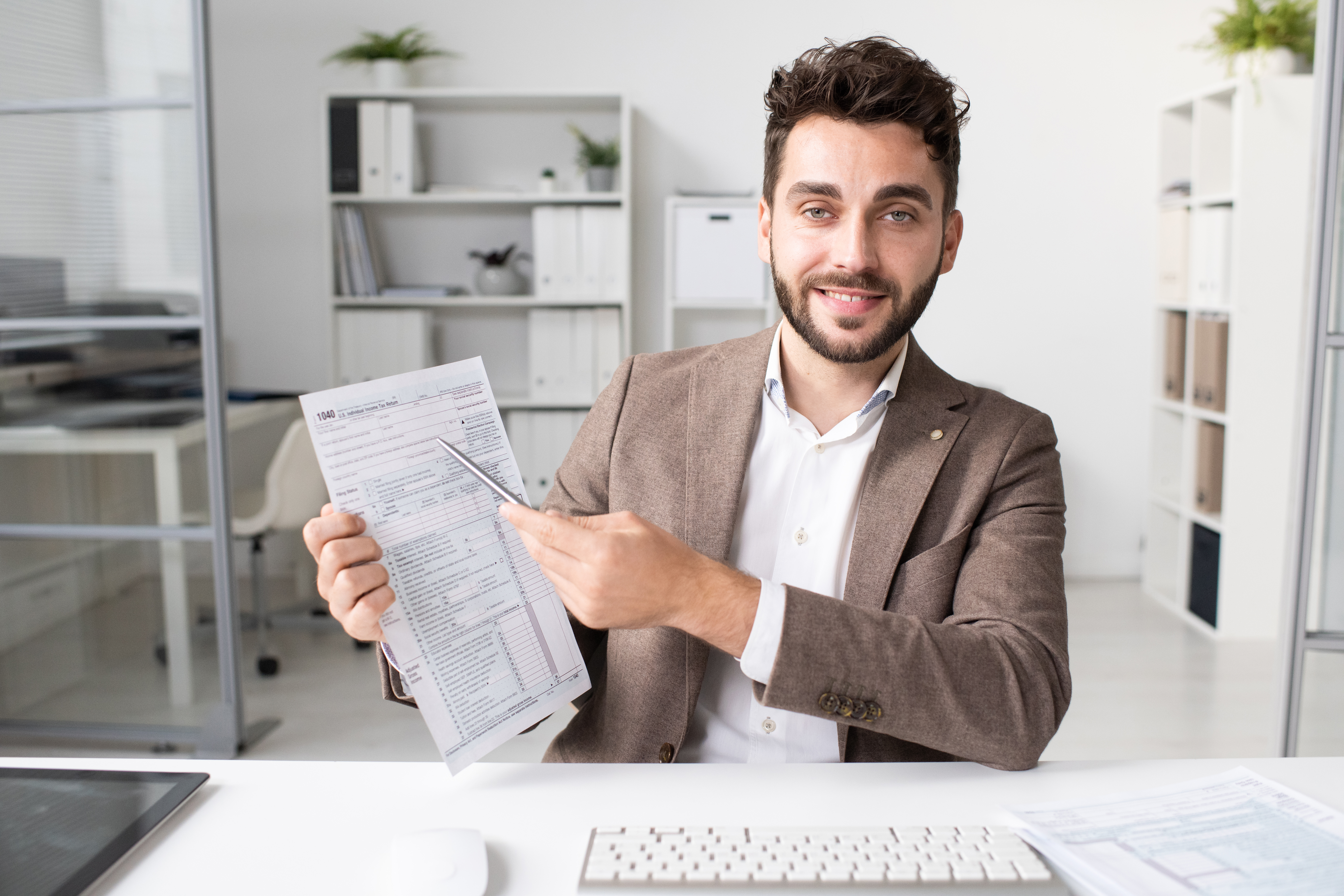 Accountant Pointing At Tax Form